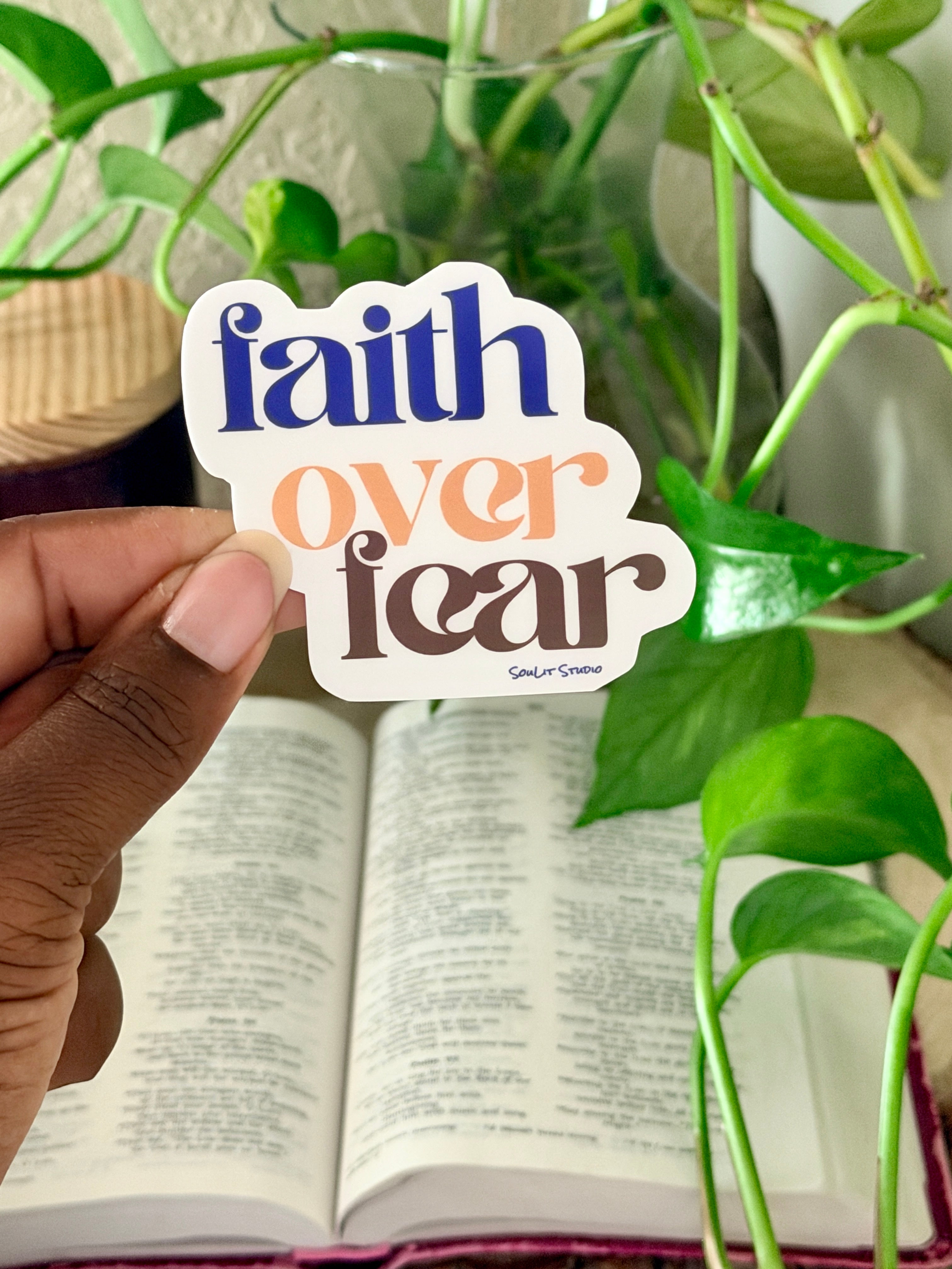 Purple, gold, and brown typography sticker reading faith over fear inspired by Psalm 56:3 for Bible study journals laptops and water bottles